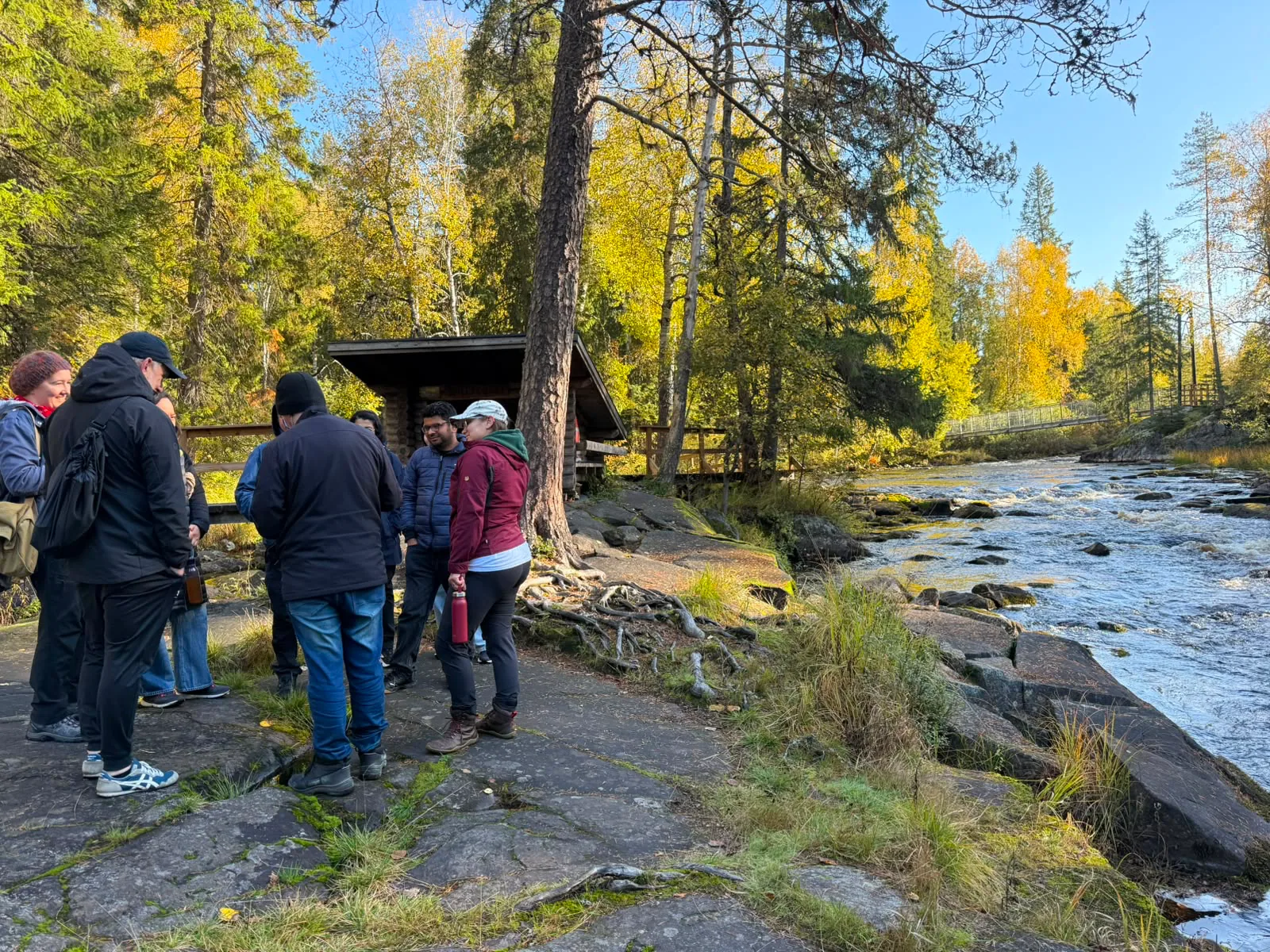 Cooperative members chatting during an autumn outing by a river