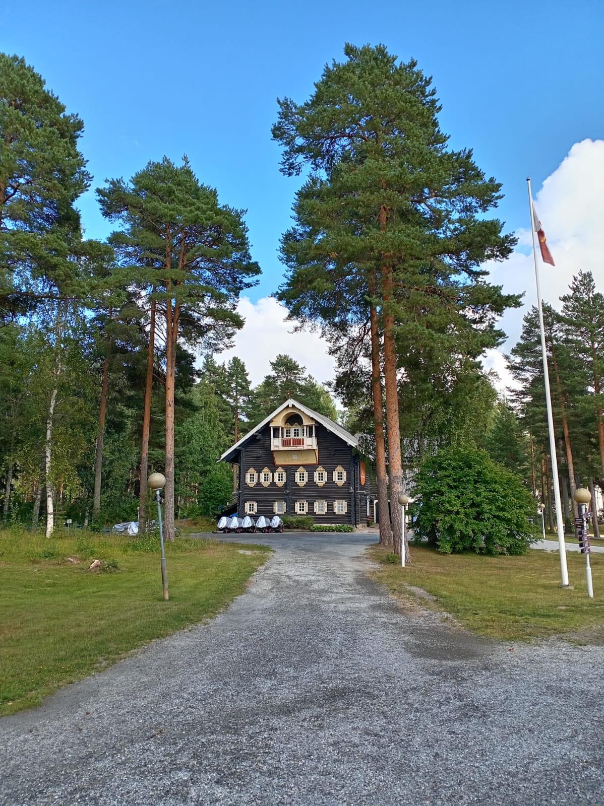 Karelian-style log building among pine trees at Bomba
