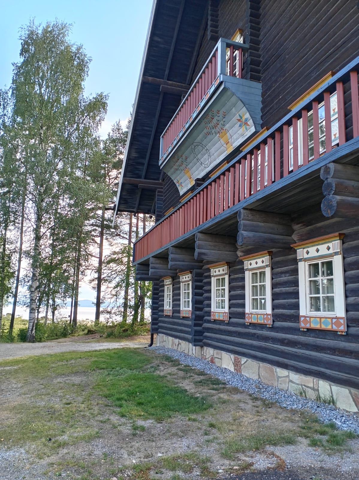 Log building with decorated balconies at Bomba